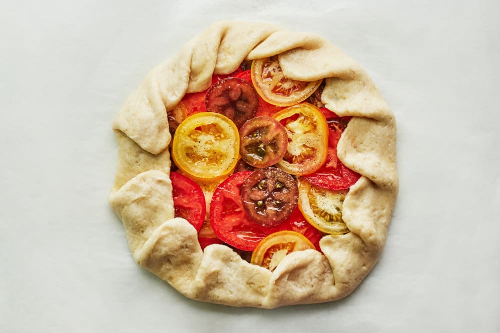 tomato-galette-unbaked-on-parchment-paper