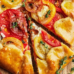 tomato-galette-on-wooden-board-with-thyme-and-tomatoes