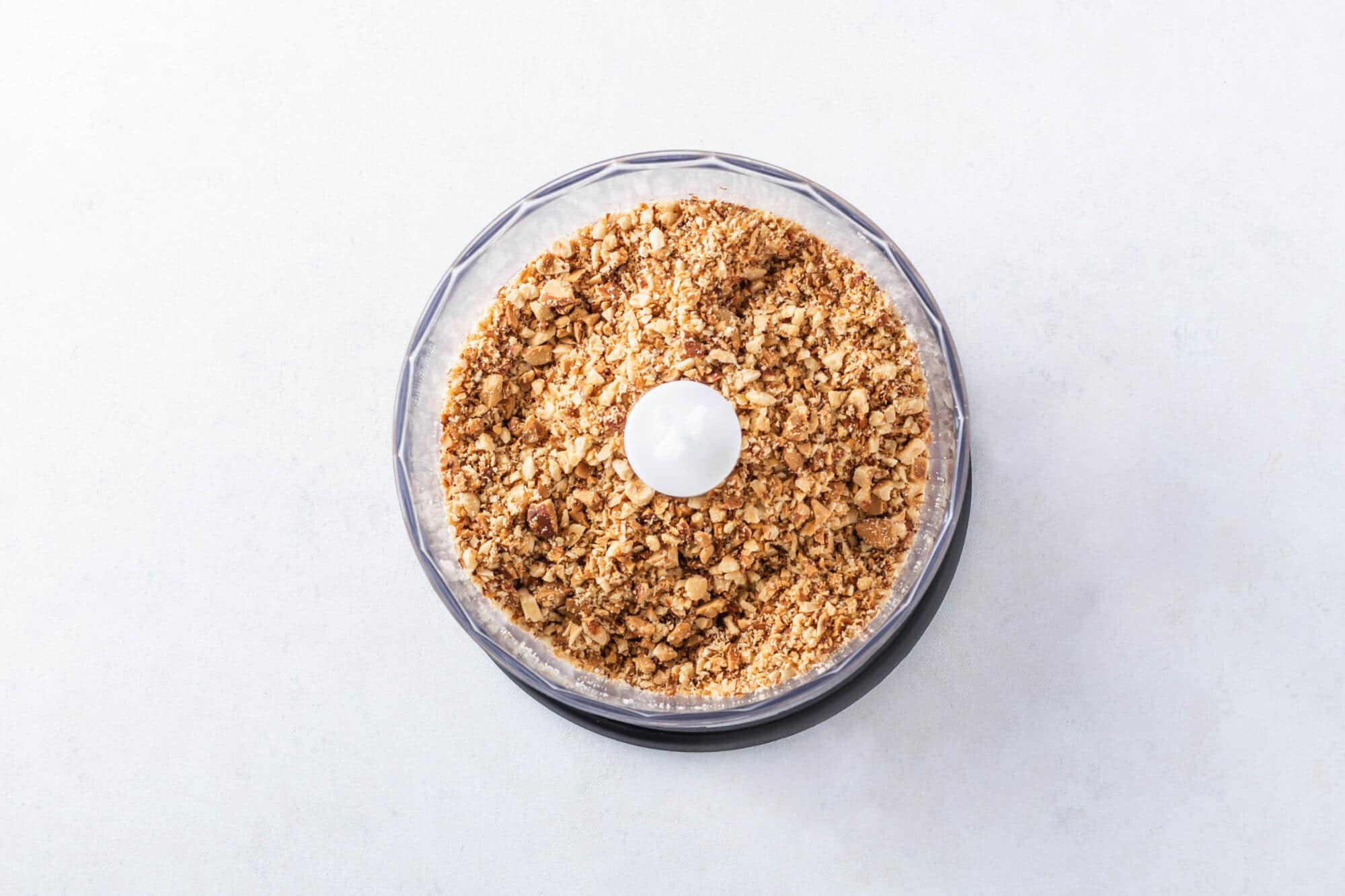 Gluten-Free Dried Fruit Bars with Nuts and Dates on The Go Chopped nuts in a food processor.