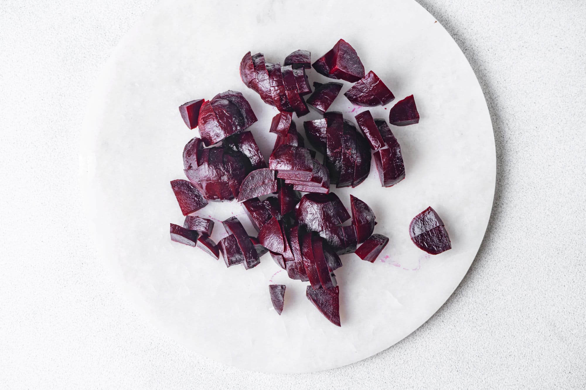 roasted-beets-peeled-and-sliced-on-a-white-plate-for-beet-salad