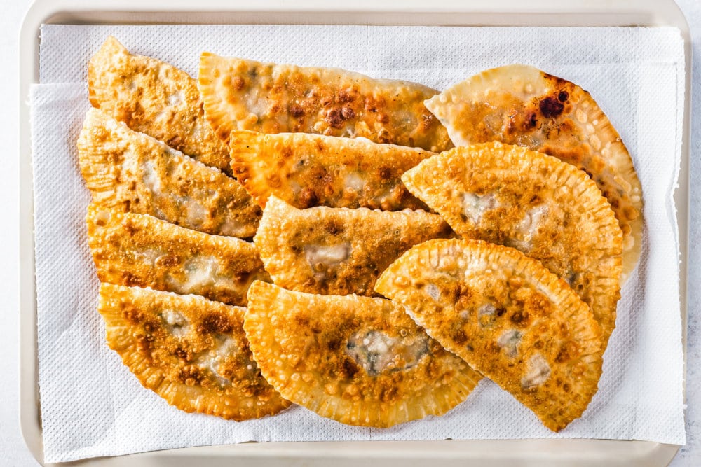 fried-chebureki-on-a-paper-towel-and-baking-tray
