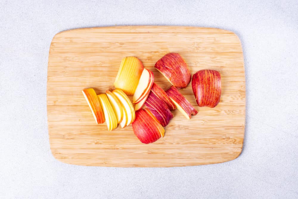thinly sliced apple on a cutting board.