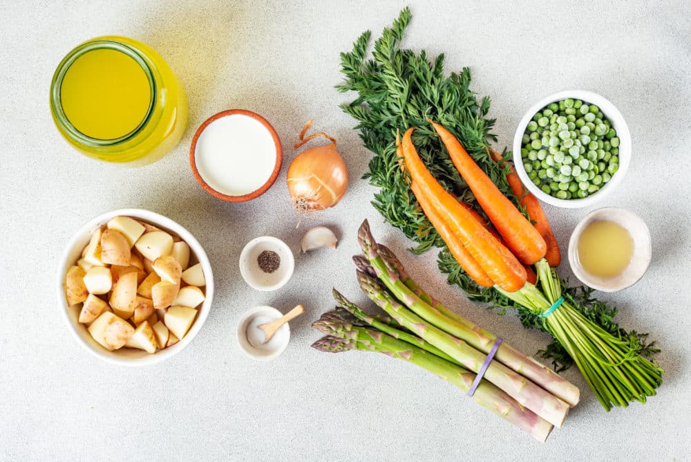 soup ingredients spread asparagus carrots peas onion carrot greens garlic sal pepper broth potatoes ghee and heavy cream.