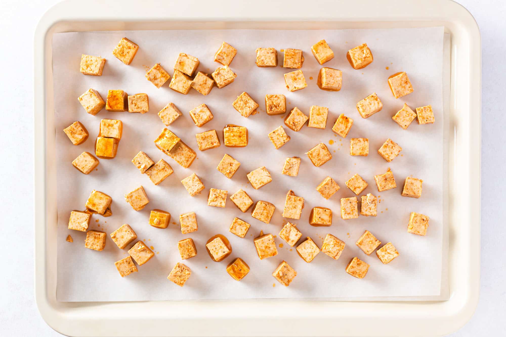 Tofu squares on a baking tray.