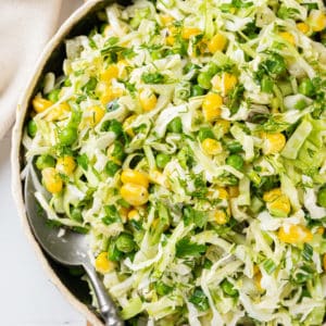 cabbage-salad-in-a-white-bowl-on-a-wooden-board-with-a-spoon