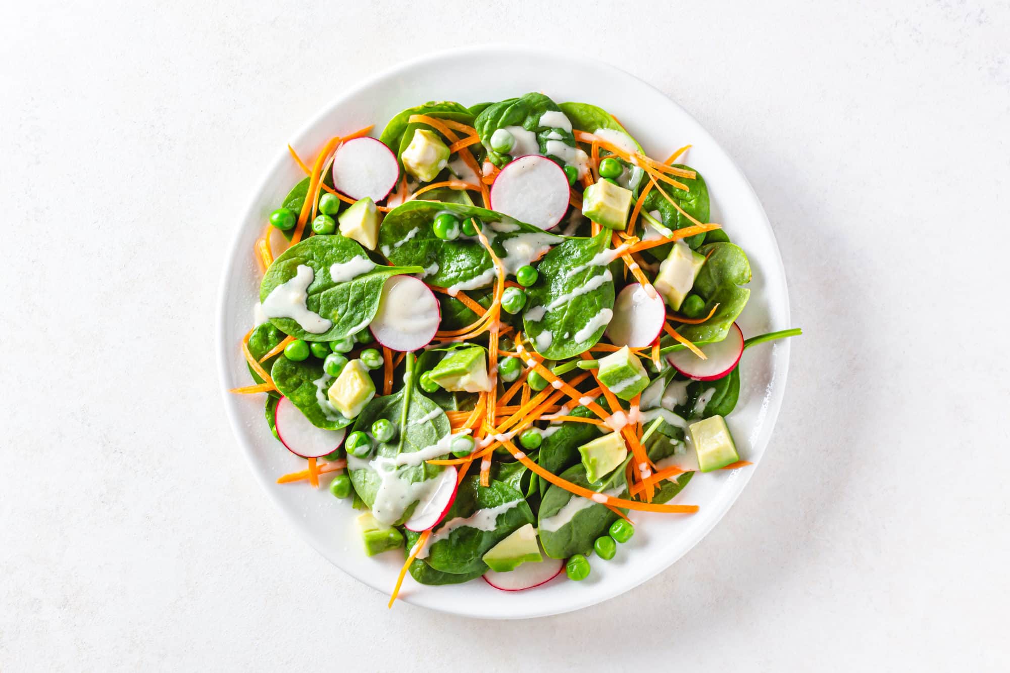 A white plate with chopped salad ingredients on it.