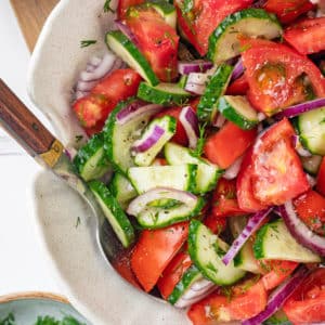 summer-salad-in-a-white-bowl-with-a-spoon