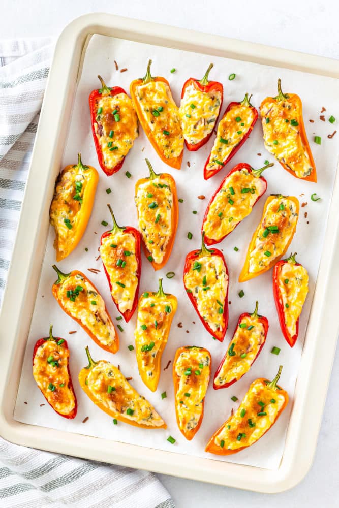 cream-cheese-bell-peppers-on-a-baking-ray-with-sprinkled-green-onion-and-a-striped-towel