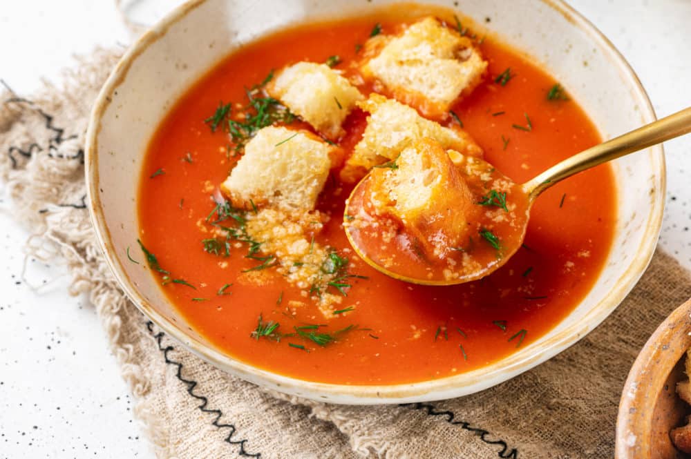 tomato-soup-in-a-bowl-with-a-spoon-and-croutons-on-top