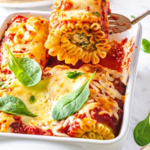 lasagna-roll-being-removed-from-a-baking-tray-with-a-spatula-and-more-lasagna-rolls-in-the-tray