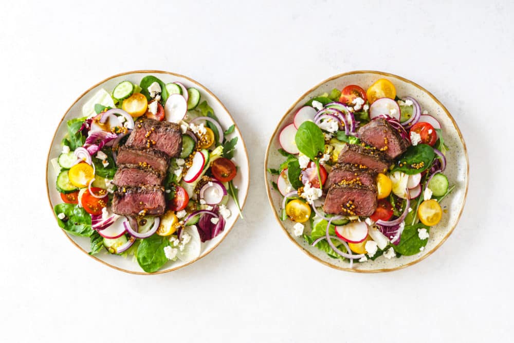 filet mignon salad on separate plates.
