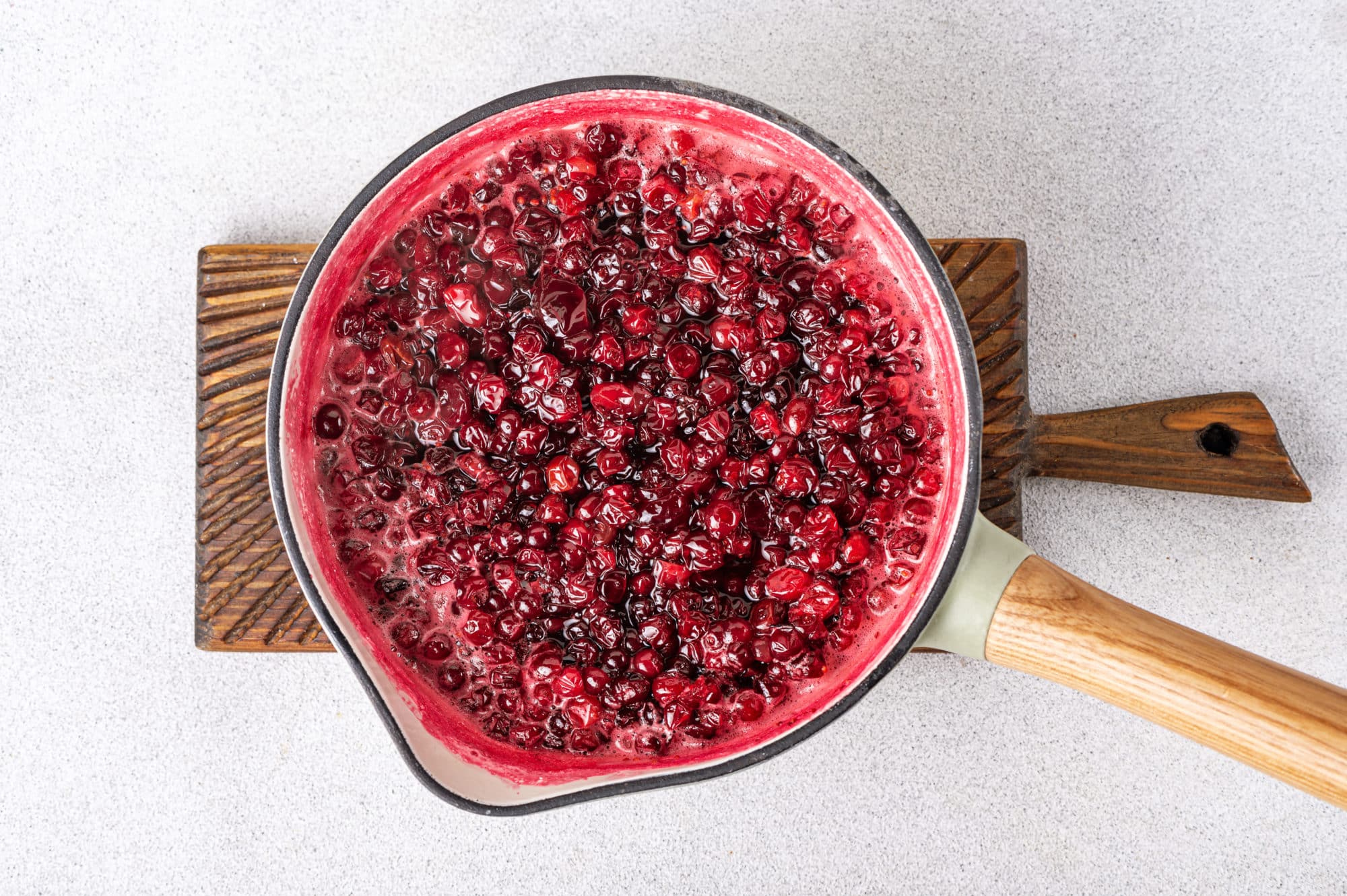 cranberry-sauce-in-a-pot-on-a-wooden-board