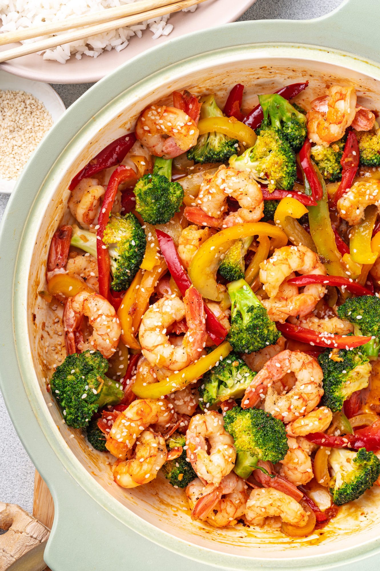 shrimp stir fry in a pot with veggies and garlic sauce.