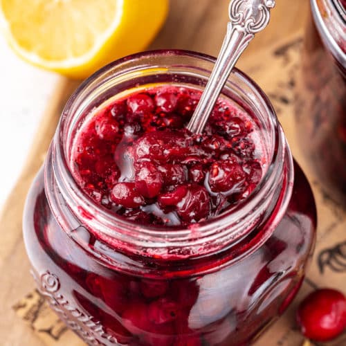 cranberry-sauce-in-glass-jars-with-a-spoon-on-a-wooden-board