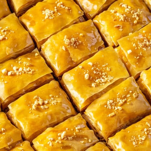 close up of  prepared baklava with walnut pieces on top.