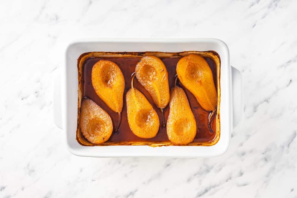 baked pears in a tray with spice mix.
