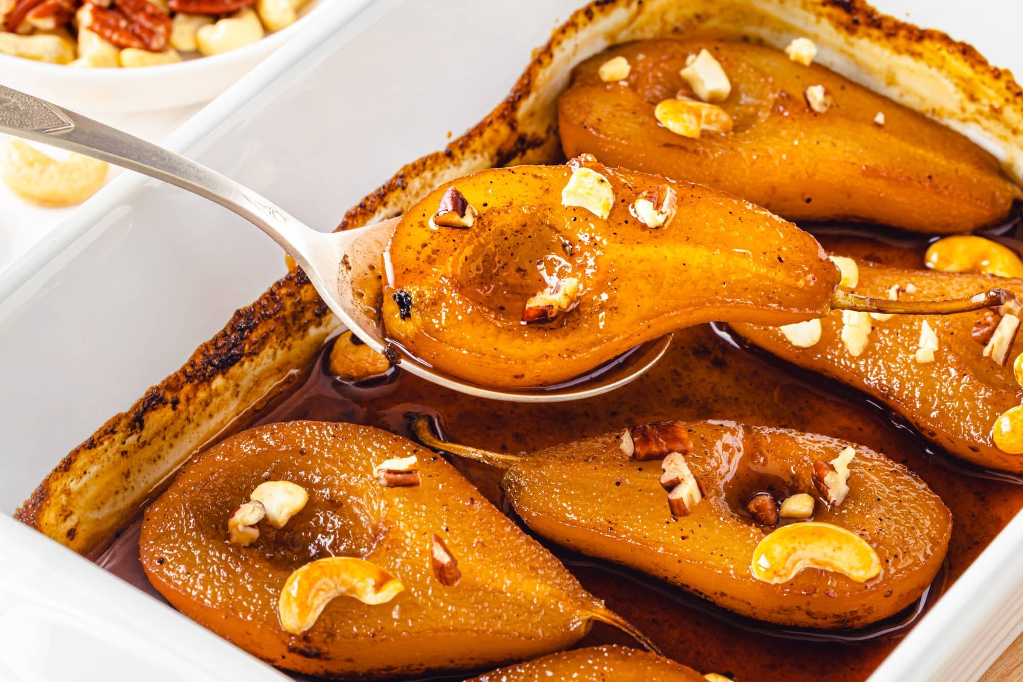 roasted-pears-in-a-baking-tray-with-a-spoon