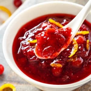 a white bowl with cranberry sauce in it.