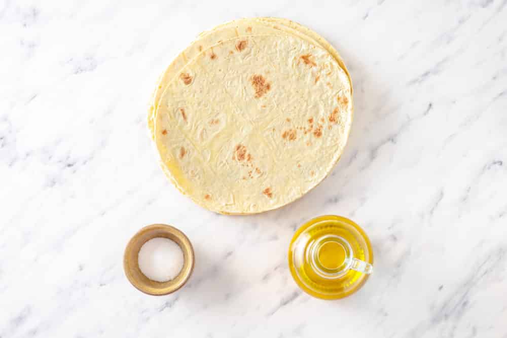 tortillas olive oil and salt ingredients to make homemade baked tortilla chips.