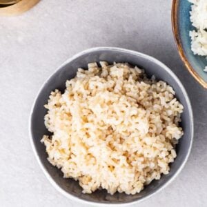 a grey bowl filled with cooked brown rice.