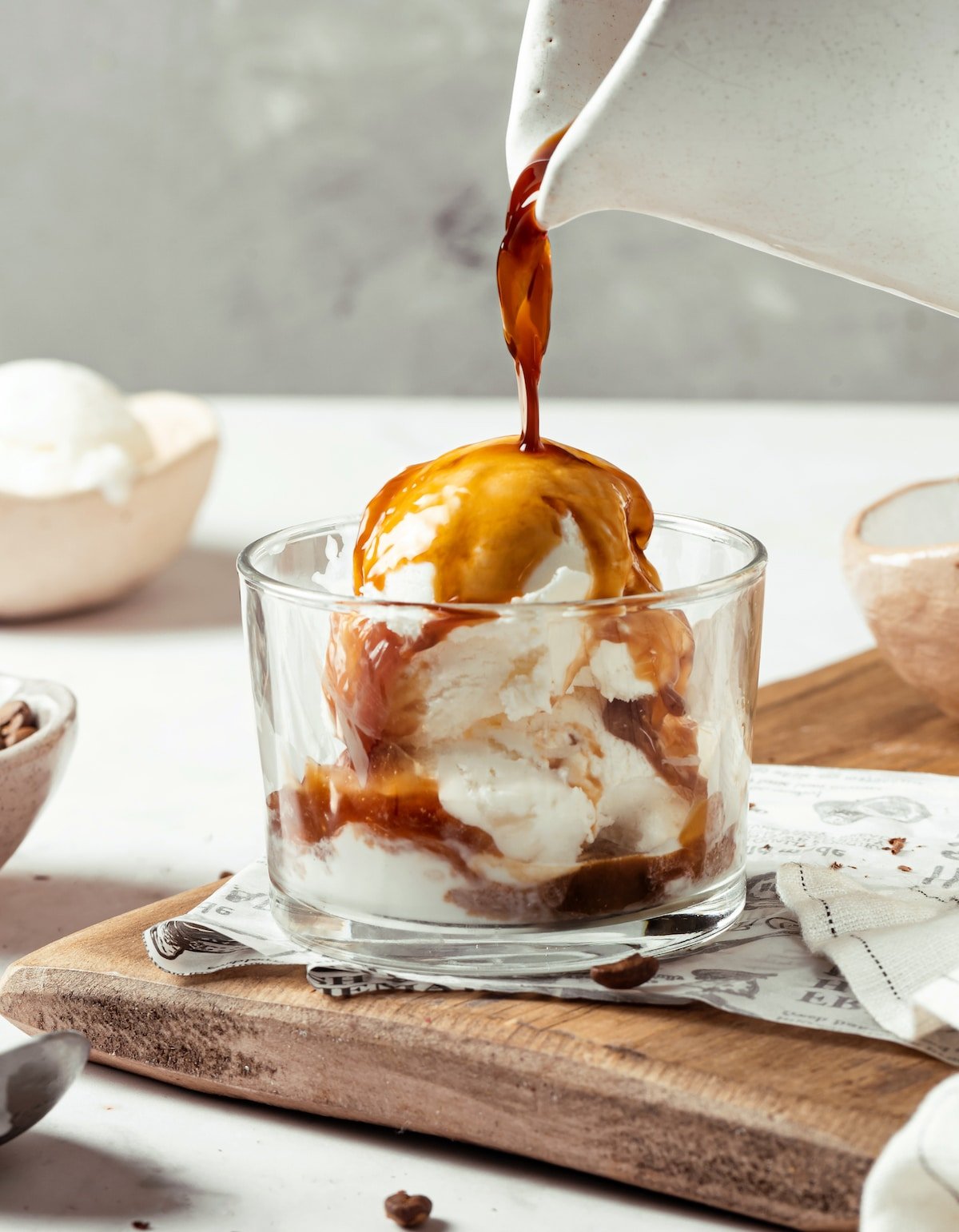 espresso being poured over a jar of vanilla ice cream