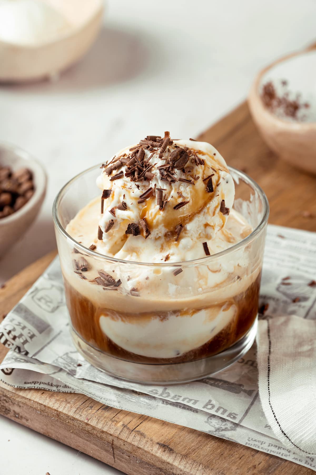 homemade affogato in a small glass cup, topped with chocolate shavings