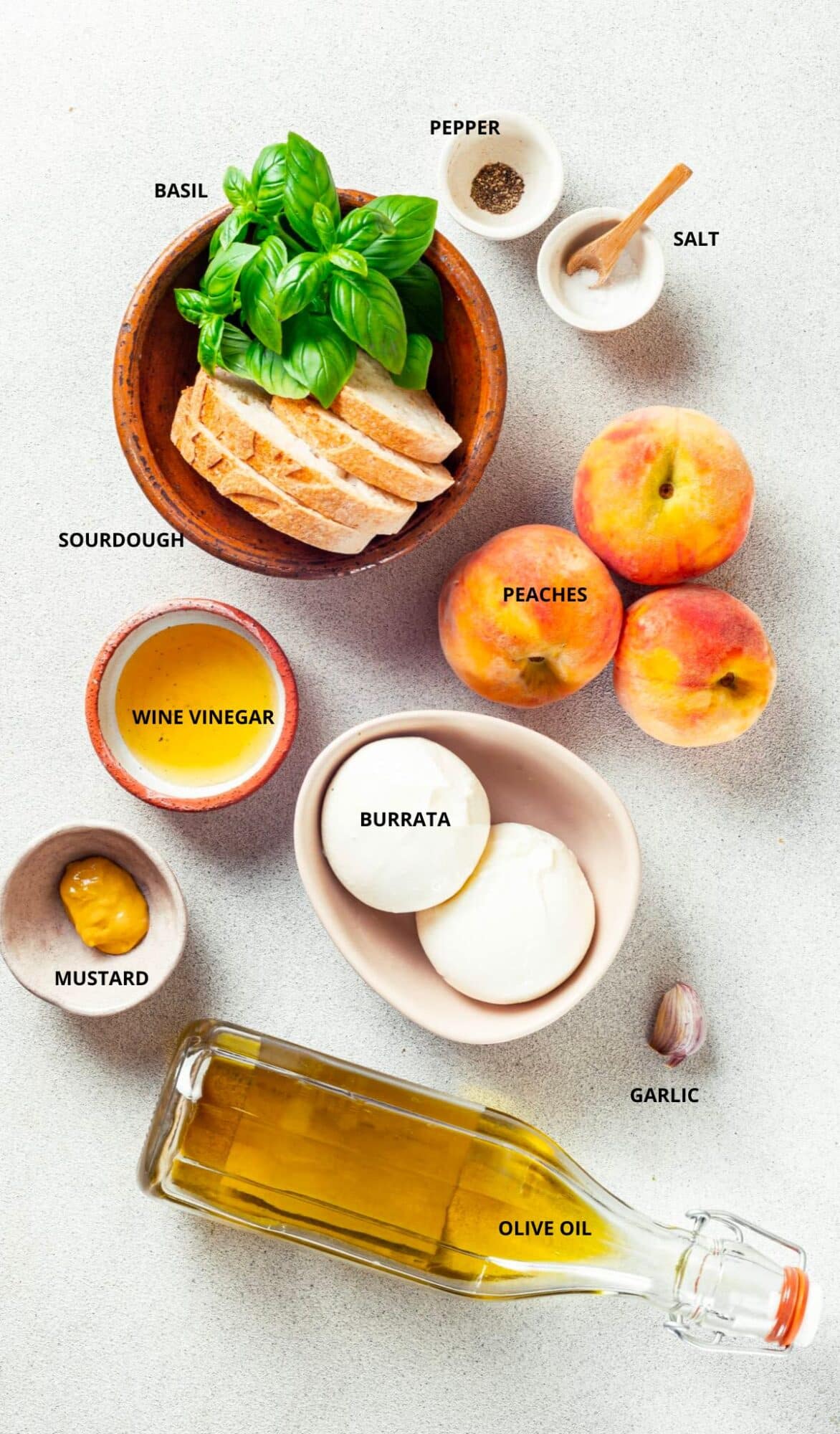 peaches and burrata ingredients with labels salt pepper basil sourdough wine vinegar peaches burrata mustard garlic and olive oil.