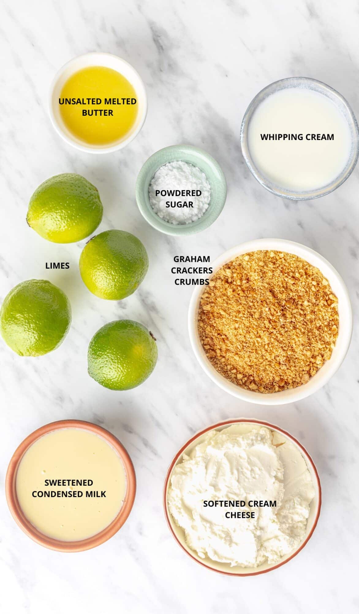 Melted butter, whipping cream, powdered sugar, whipping cream, four limes, graham crackers, sweetened condensed milk, and cream cheese in individual dishes for key lime dessert.