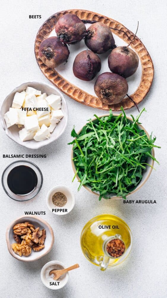 beet salad ingredients beets, baby arugula, olive oil, pepper, balsamic dressing, feta cheese, walnuts, salt, and olive oil.