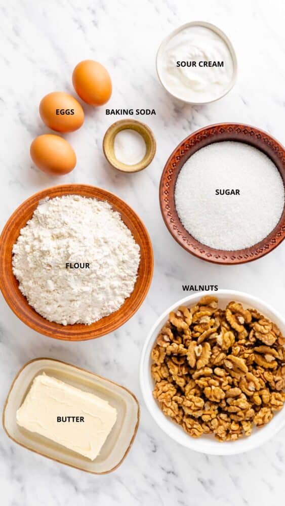 baklava ingredients sour cream, baking soda, eggs, sugar, flour, walnuts, and butter.