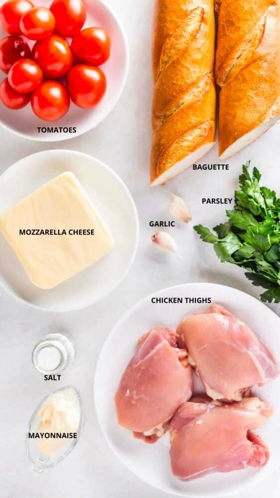 Bruschetta chicken bake ingredients baguette, tomatoes, parsley, garlic, mozzarella cheese, salt, mayonnaise, and chicken thighs.