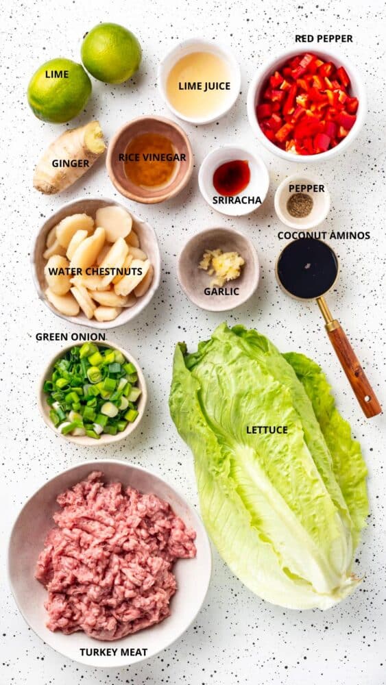 turkey lettuce wraps ingredients red pepper, lime juice, lime, ginger, rice vinegar, sriracha, pepper, coconut aminos, water chestnuts, garlic, green onion, lettuce, and turkey meat.