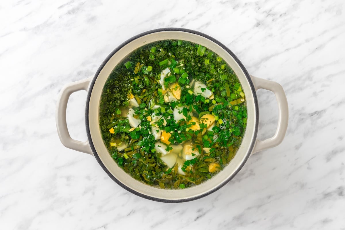 Green Sorrel Soup adding greens and eggs