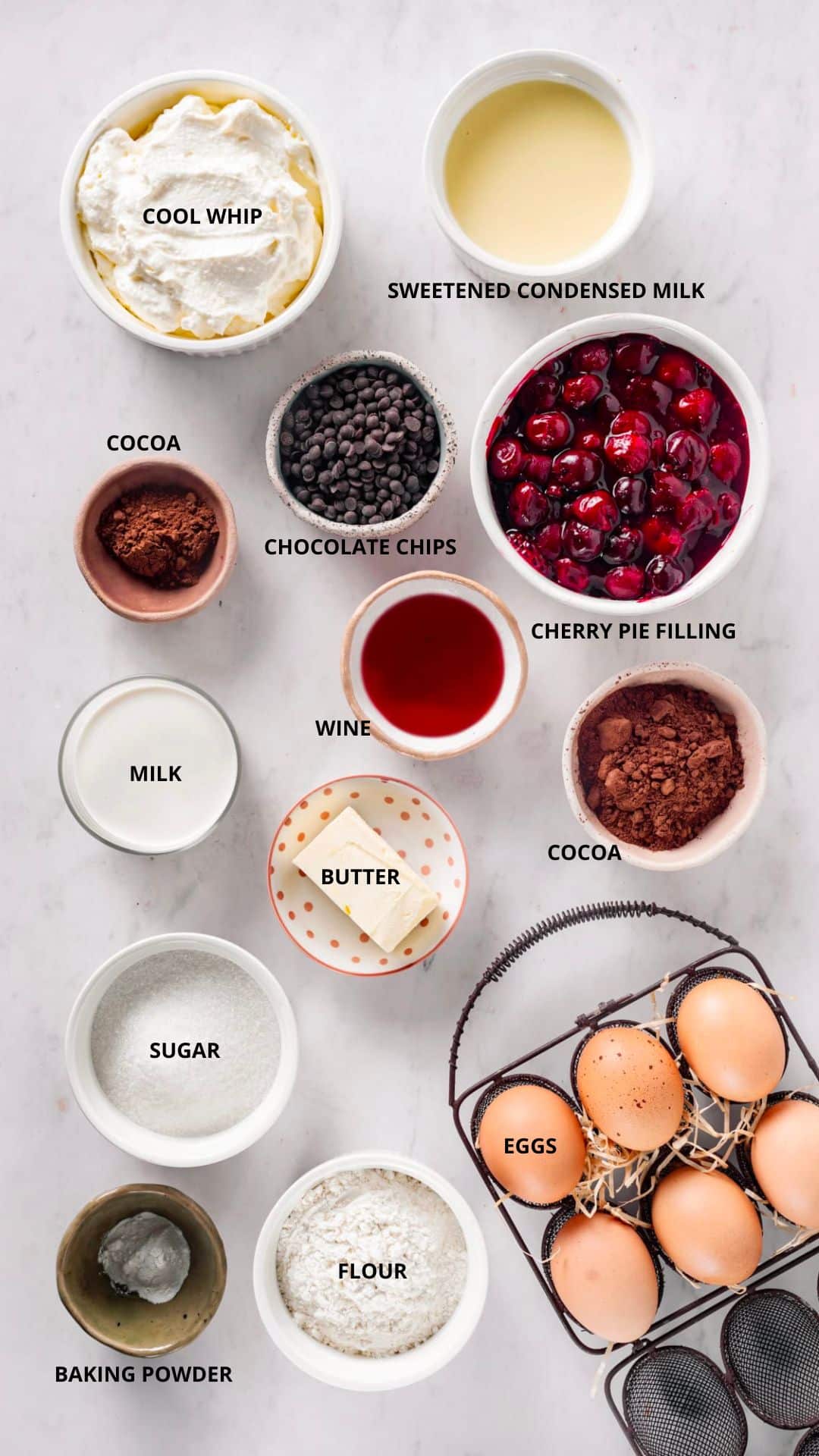 drunken cherry chocolate cake ingredients- sweetened condensed milk, cool whip, cocoa, chocolate chips, cherry pie filling, cocoa, milk, wine, butter, sugar, eggs, flour, and baking powder.