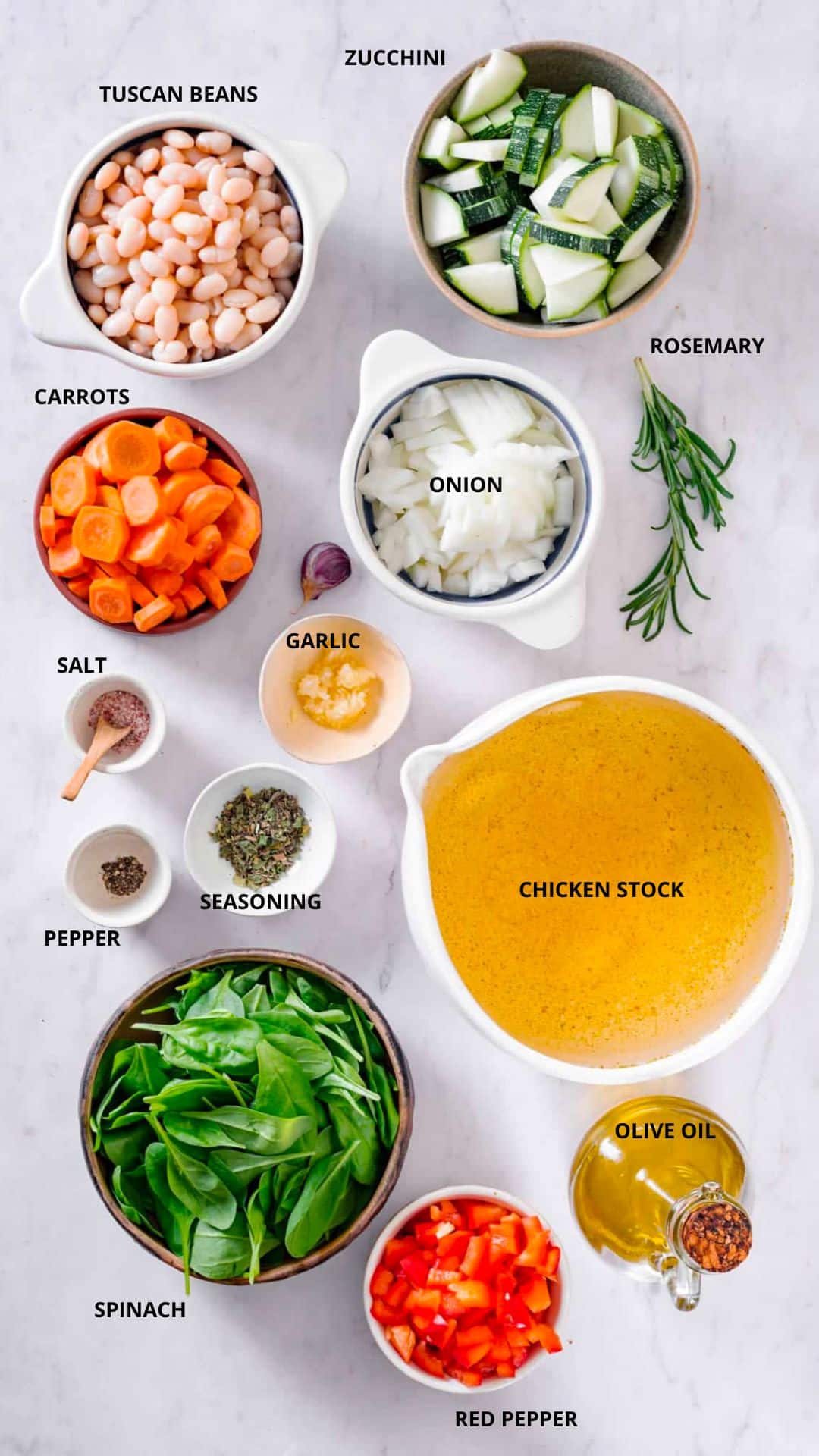 tuscan soup ingredients- zucchini, rosemary, tuscan beans, carrots, onion, garlic, salt, pepper, seasoning, chicken stock, olive oil, spinach, and red pepper.