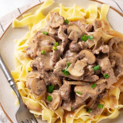 beef stroganoff with creamy sauce over egg noodles