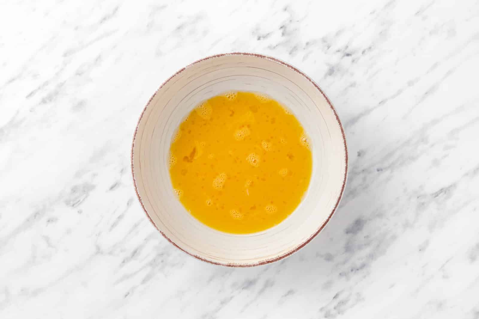 whisked eggs in a bowl 