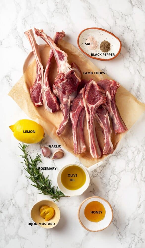 lamb chop ingredients laid out on marbled background.