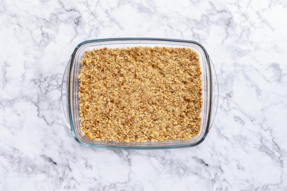 Baked bottom layer for pretzel jello salad in a glass baking dish.