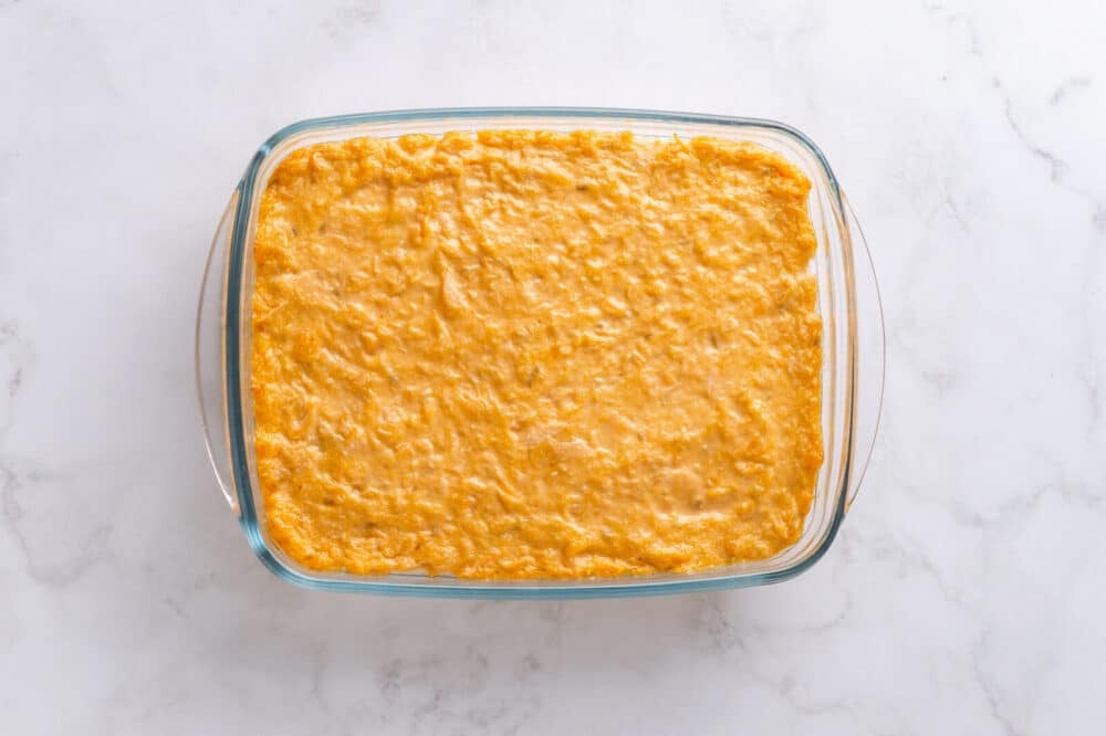 Salmon Sushi Bake with Spicy Mayo Baked sushi bake in a large glass dish.