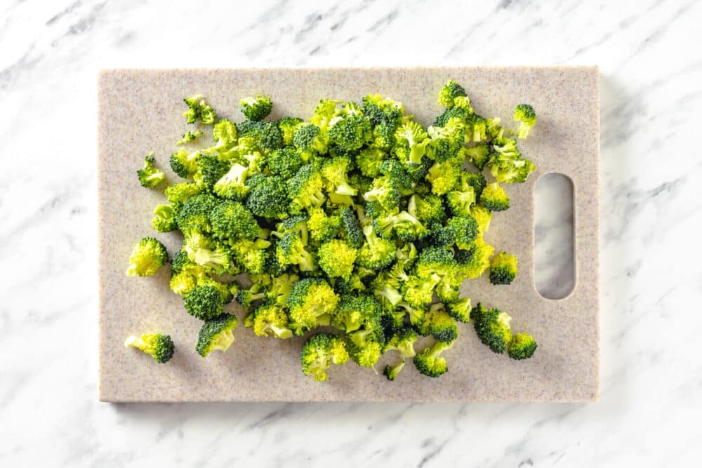 Chopped broccoli on a cutting board.