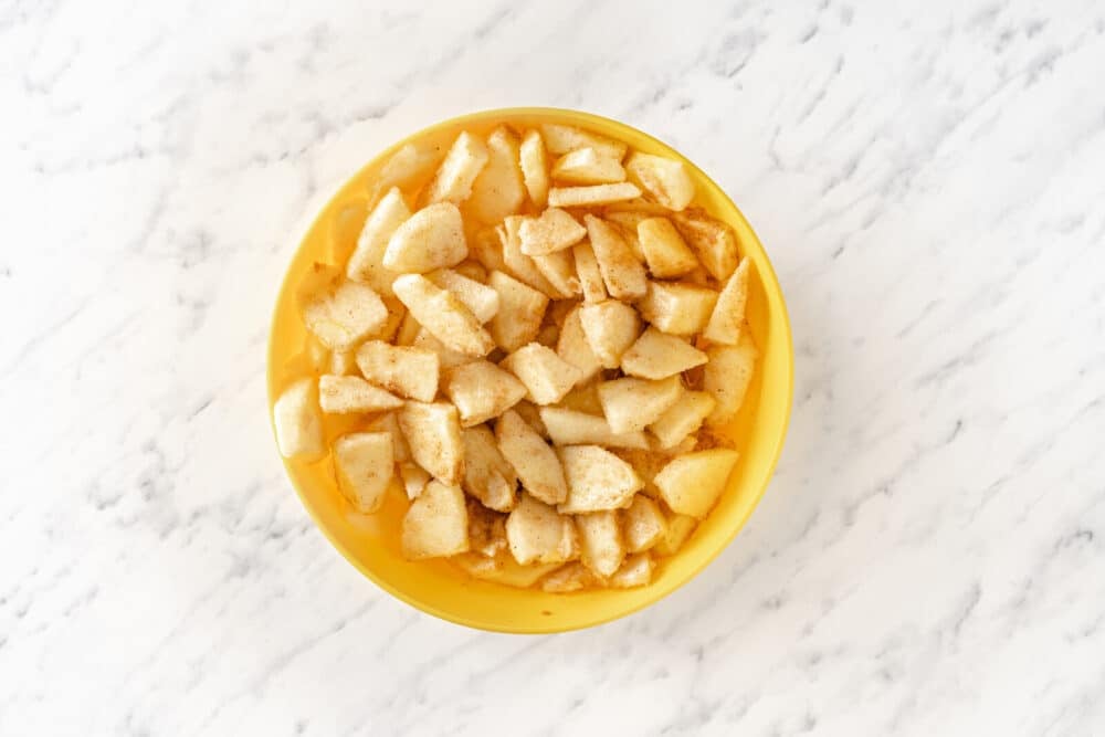 Cinnamon apple sugar mix in a yellow bowl.