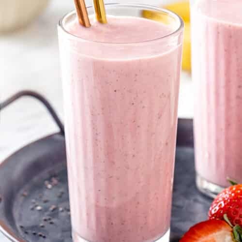 Close up of strawberry smoothie with metal straws.