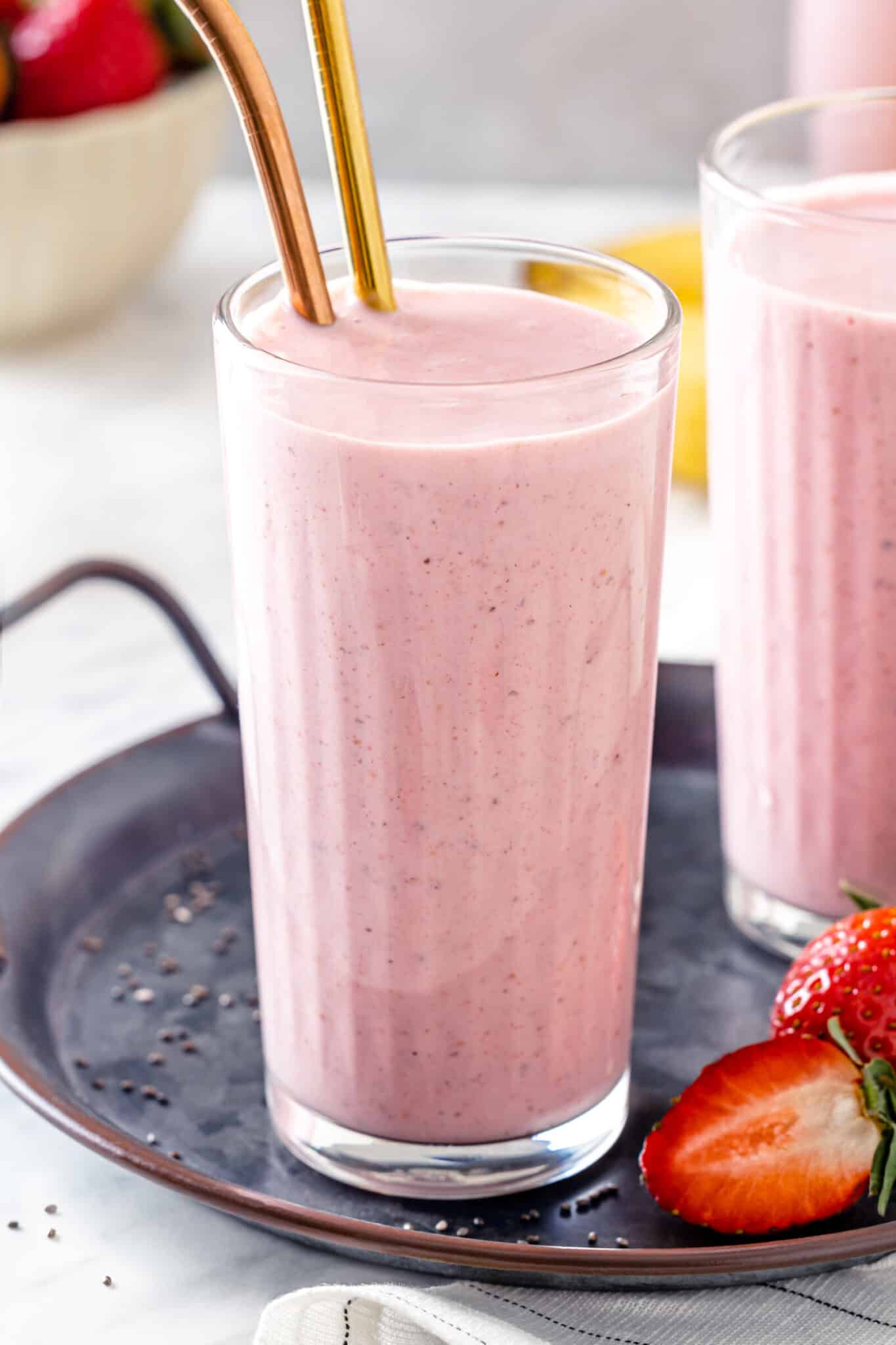 Close up of strawberry smoothie with metal straws.