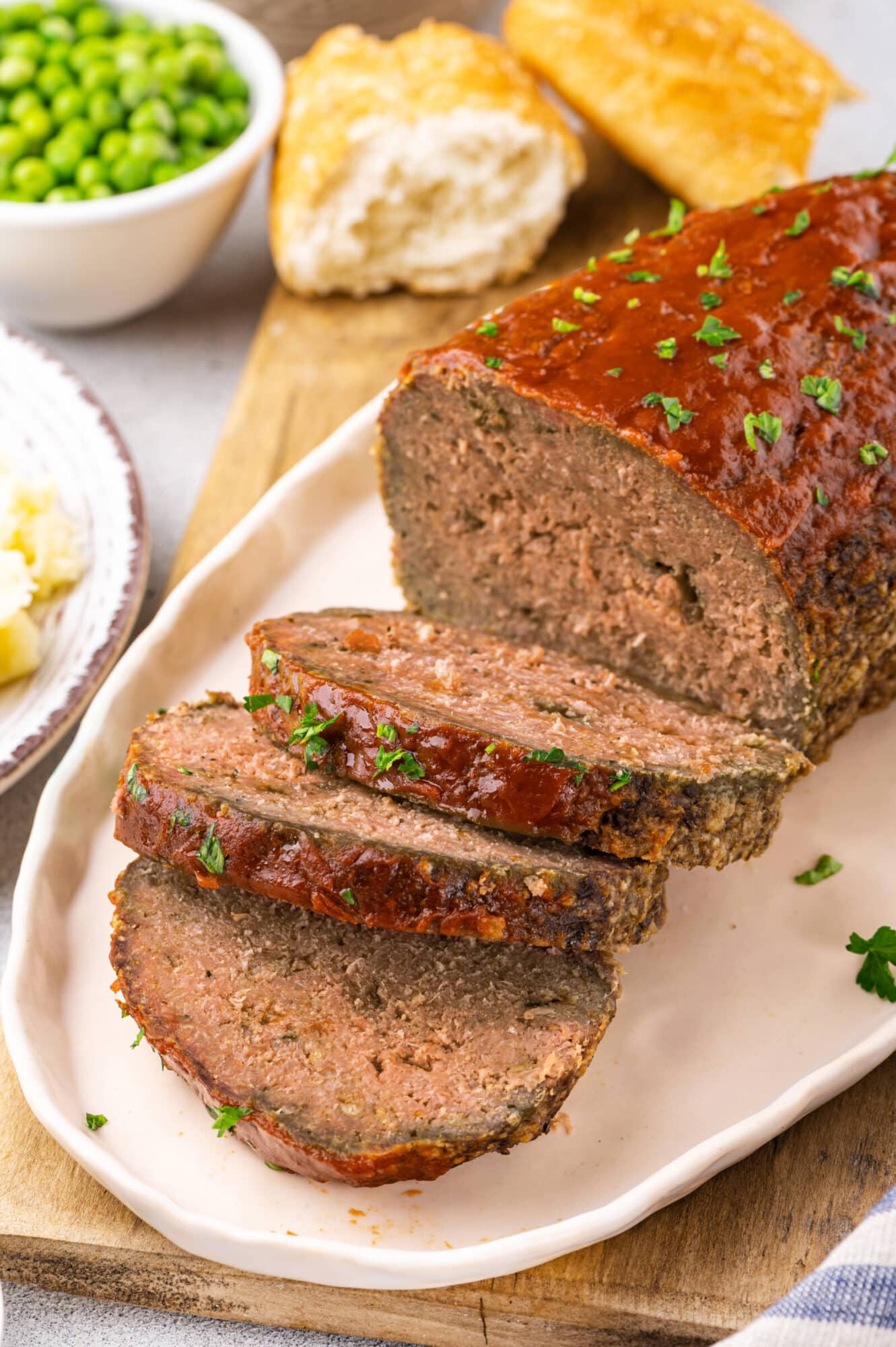 Enjoying meatloaf served on an oval plate.