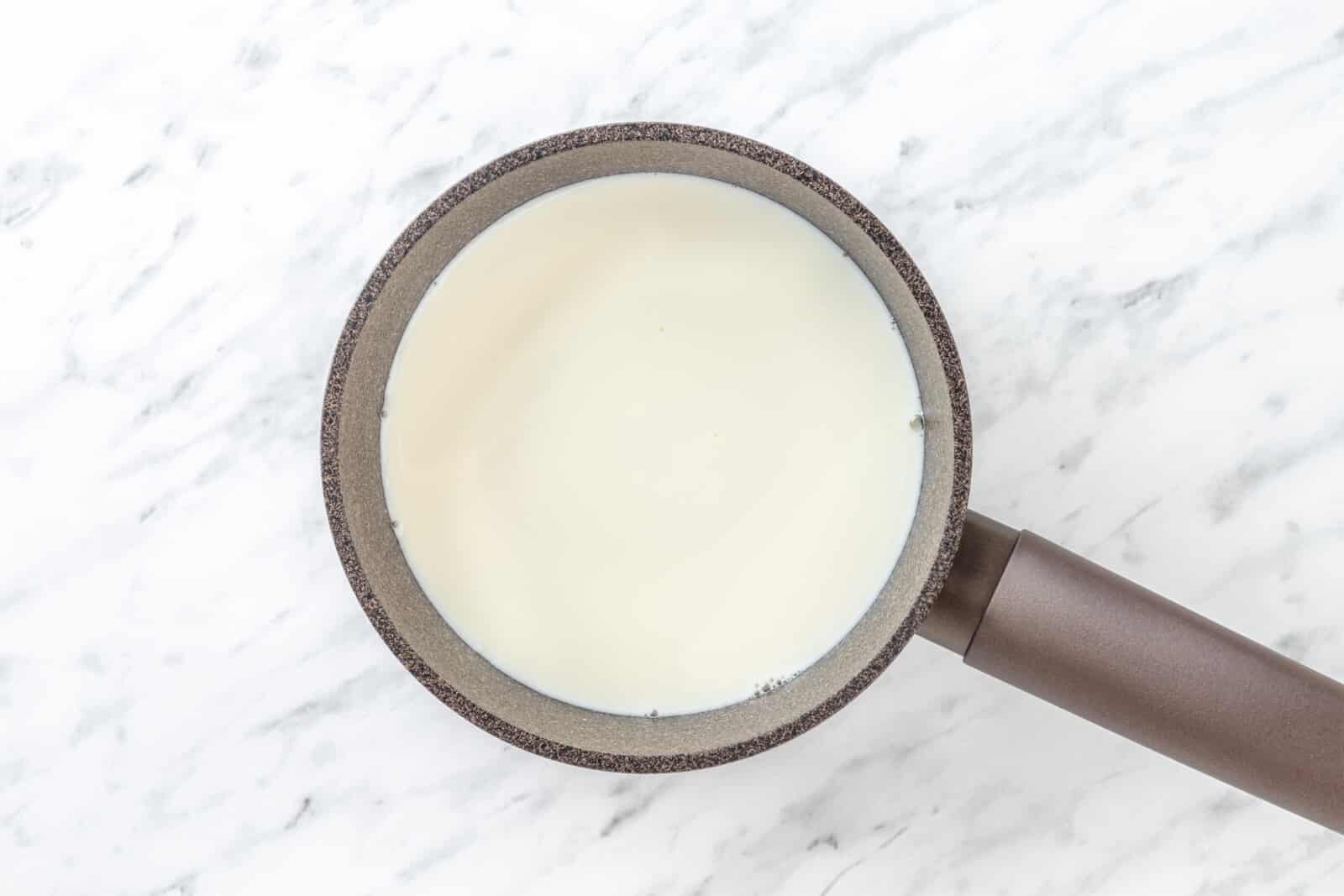 Chai Tea Latte with Warm Spices Milk in a saucepan.