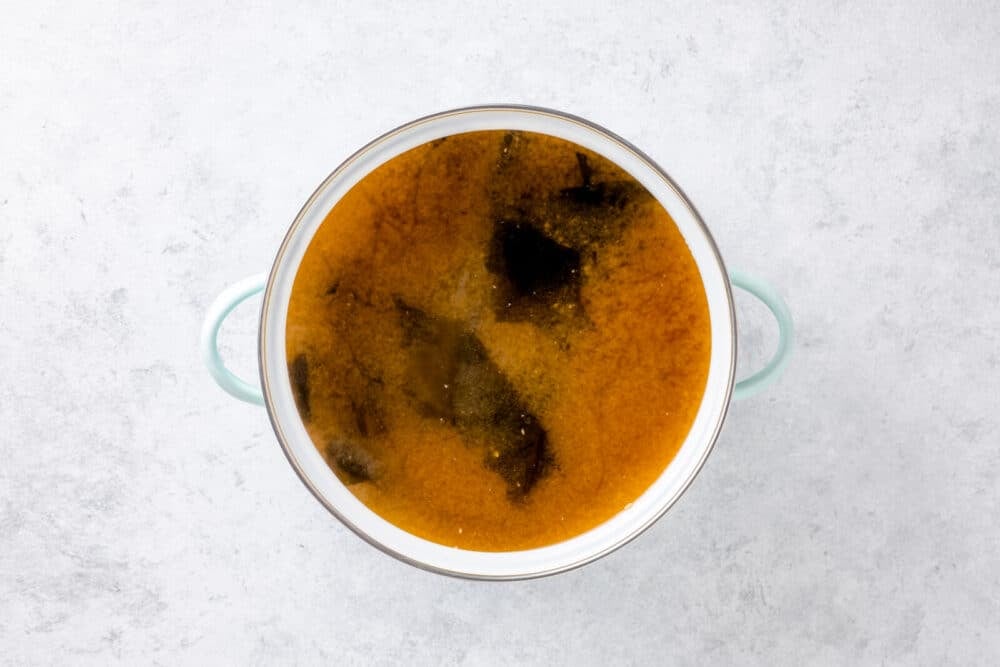 Miso paste and wakame cooking in broth.