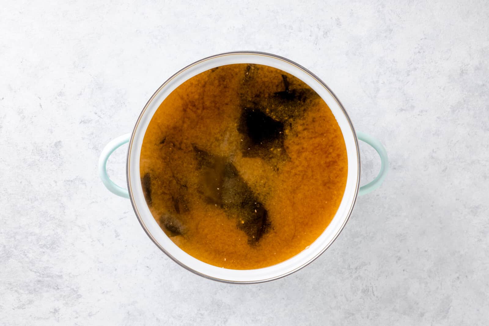How To Make Miso Soup At Home Miso paste and wakame cooking in broth.