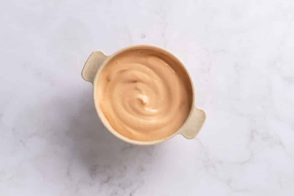 Salmon Sushi Bake with Spicy Mayo Mixed spicy mayo in a small bowl with handles.