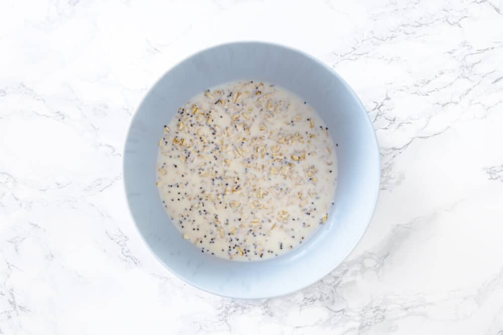 Overnight oat mixture put together in a blue bowl.